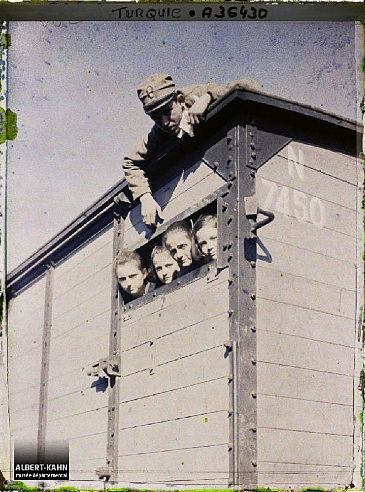 A woman and 3 children in a freight train, Adrianople. 